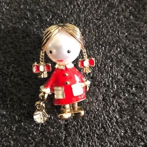 Girl in enamel red coat ponytails brooch